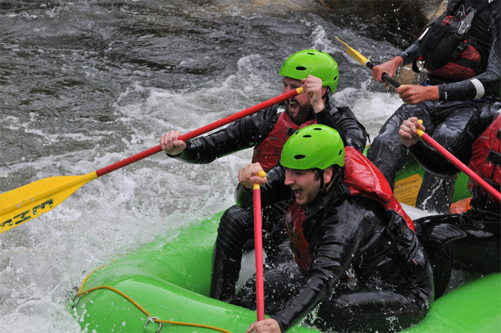 group of friends whitewater rafting