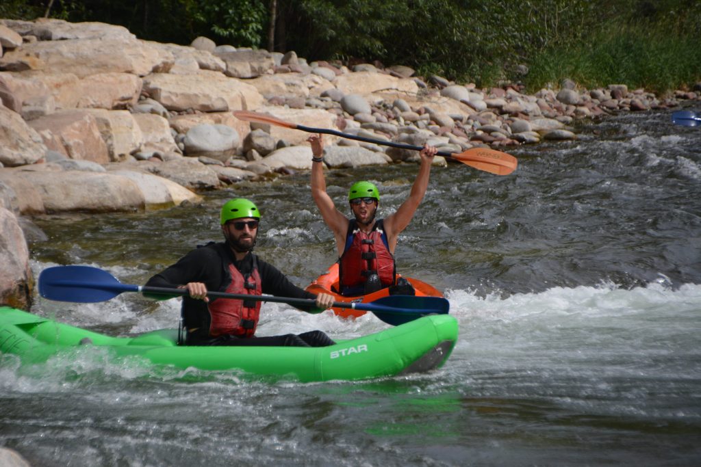 2 men in inflatable kayaks